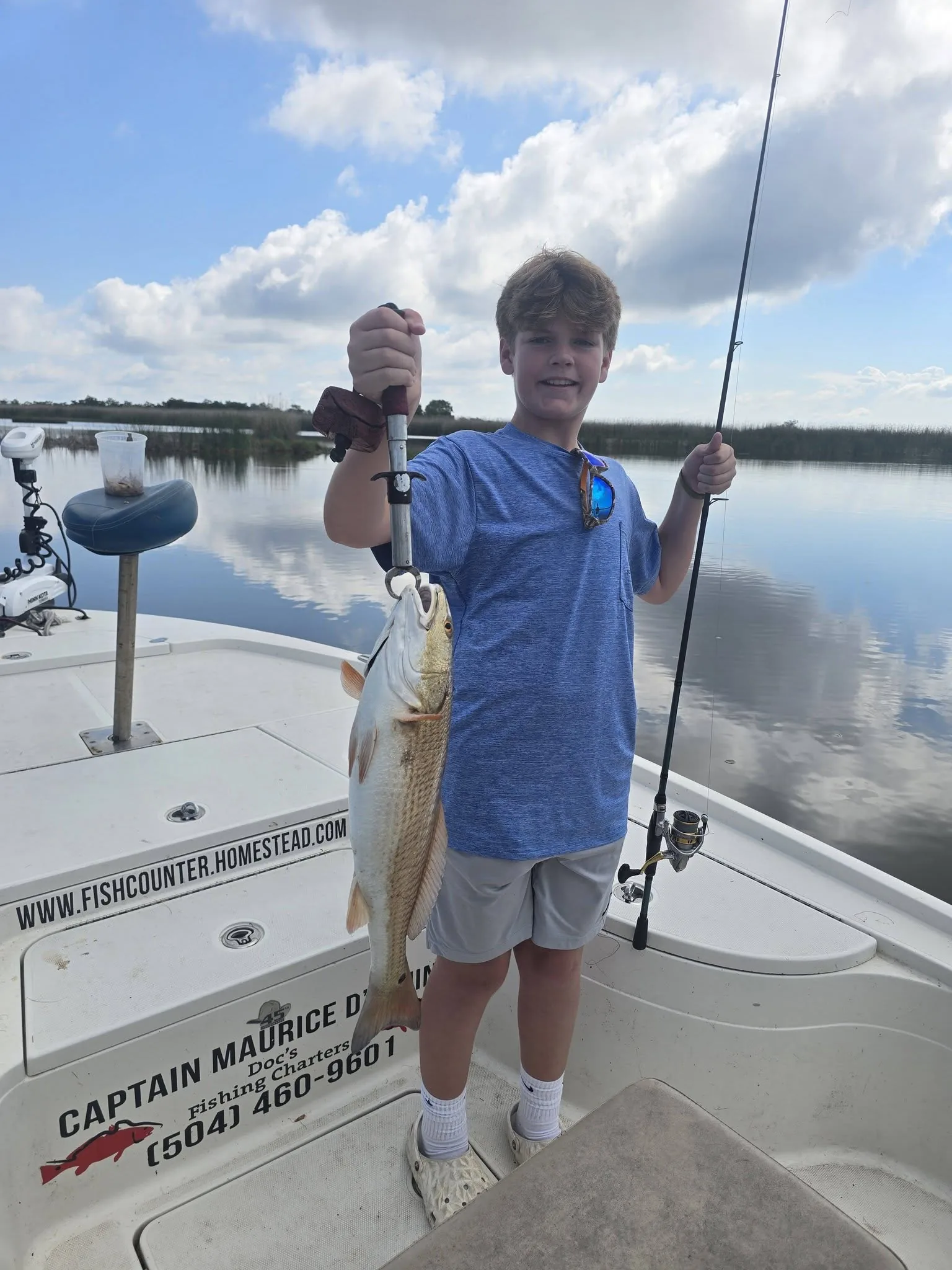 Young angler holding a redfish